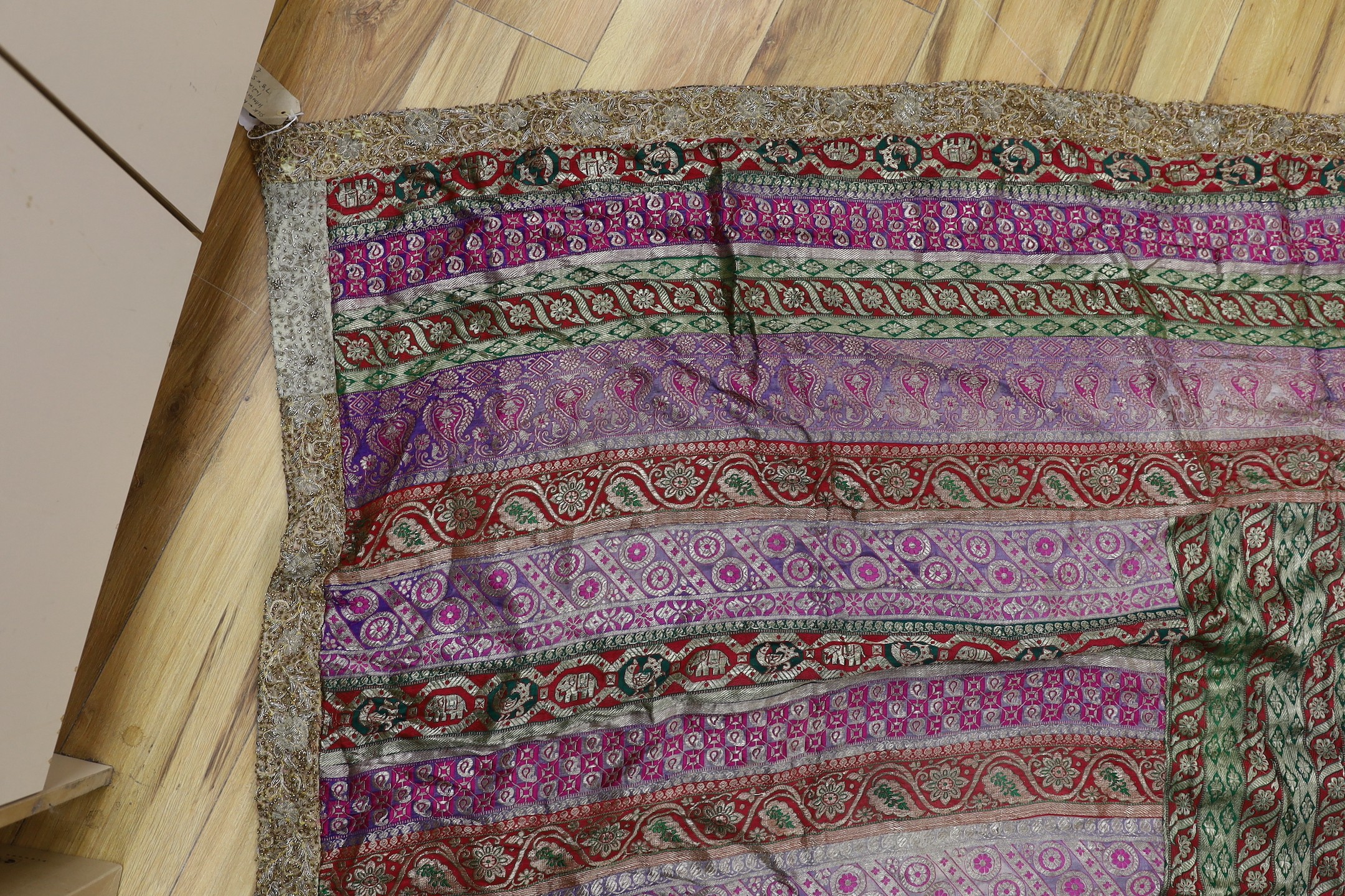 A French 18th century woolwork cushion, 2 chair covers, another panel, a tasselled brocade cushion and an Indian metallic brocaded patchworked cover